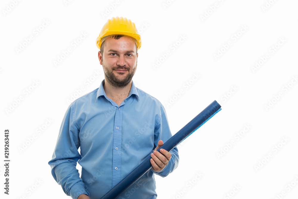Portrait of young architect with yellow helmet holding blueprints Portrait of young architect with yellow helmet holding blueprints