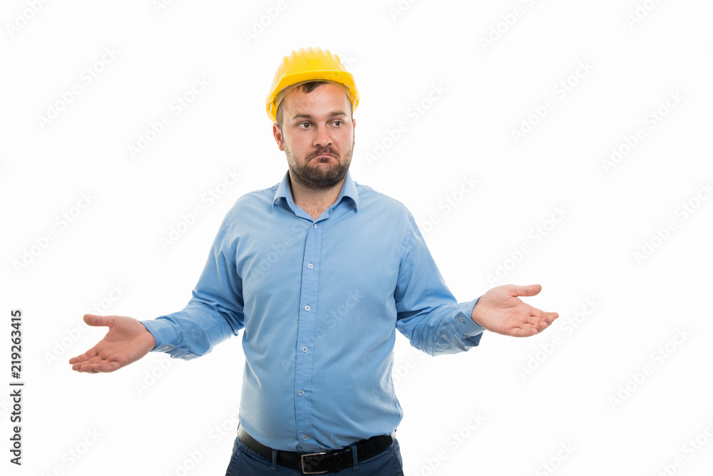 Young architect with yellow helmet showing don't know gesture Young architect with yellow helmet showing don't know gesture