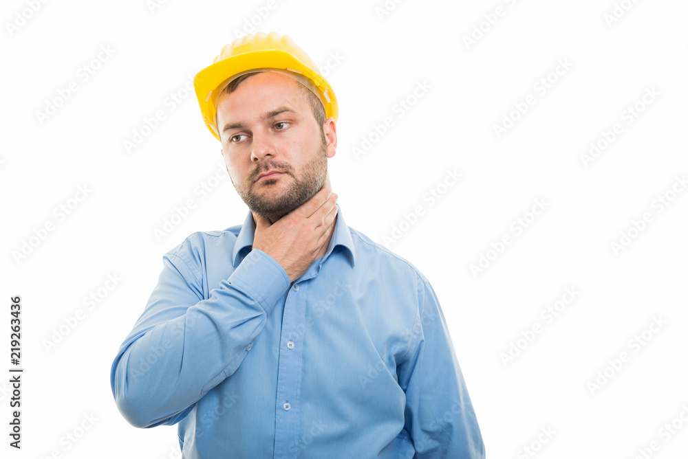 Young architect with yellow helmet showing throat pain gesture