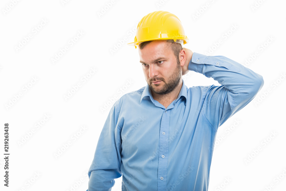 Young architect with yellow helmet showing neck pain gesture Young architect with yellow helmet showing neck pain gesture