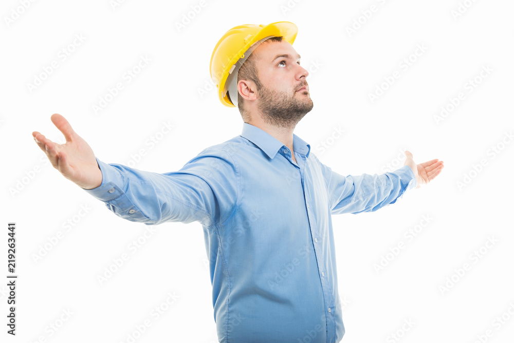 Side view architect with yellow helmet standing with open arms Side view architect with yellow helmet standing with open arms