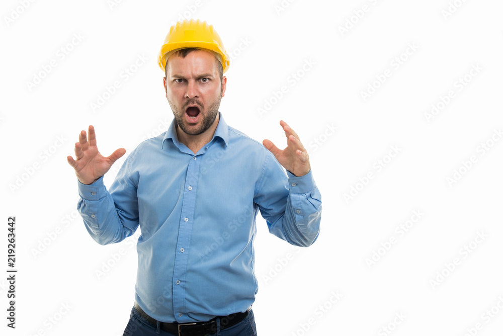 Young architect with yellow helmet showing screaming gesture