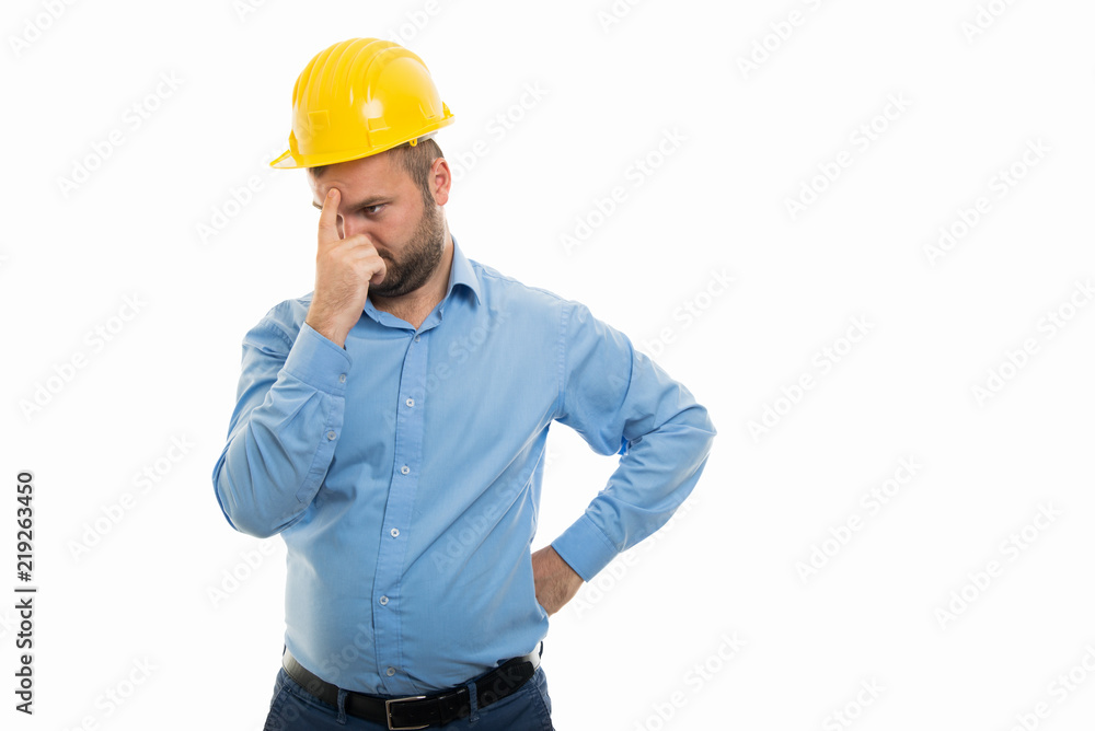 Young architect with yellow helmet showing contemplating gesture Young architect with yellow helmet showing contemplating gesture