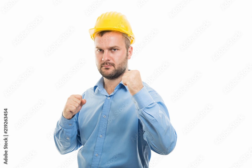 Young architect with yellow helmet showing both fists gesture Young architect with yellow helmet showing both fists gesture