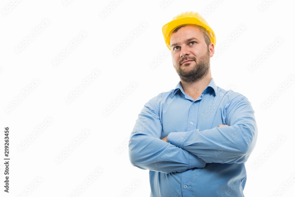 Low angle of young architect standing with arms crossed Low angle of young architect standing with arms crossed