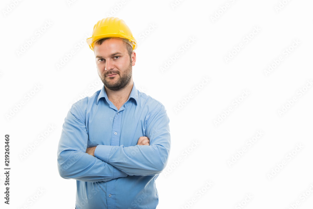 Young architect with yellow helmet standing with arms crossed Young architect with yellow helmet standing with arms crossed