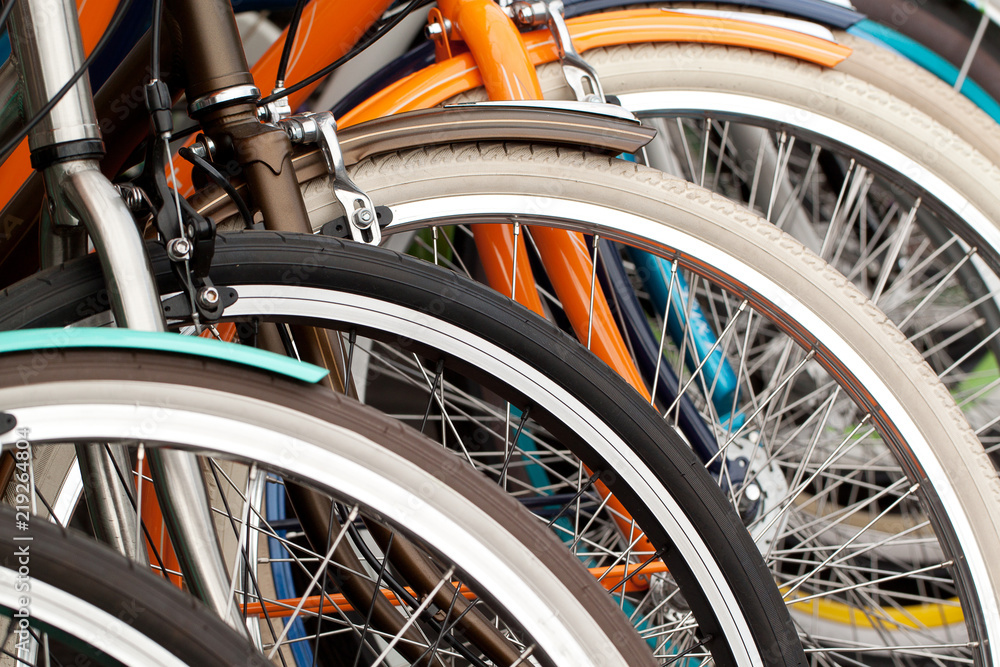 bicycle wheels standing in a row in a warehouse or in a store