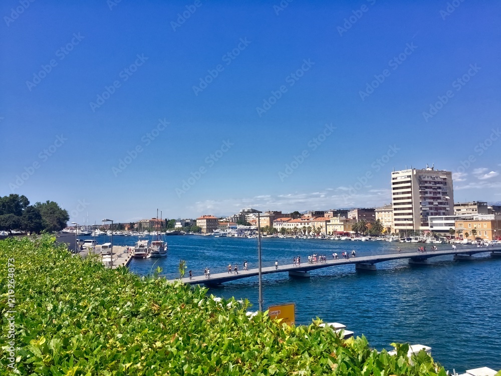 Fototapeta premium Long bridge across sea water in zadar croatia on a sunny day 