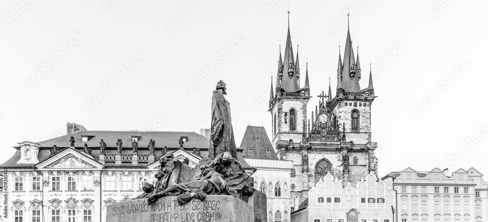 Jan Hus Monument and Church of Our Lady before Tyn at Old Town Square, Prague, Czech Republic. Black and white image.