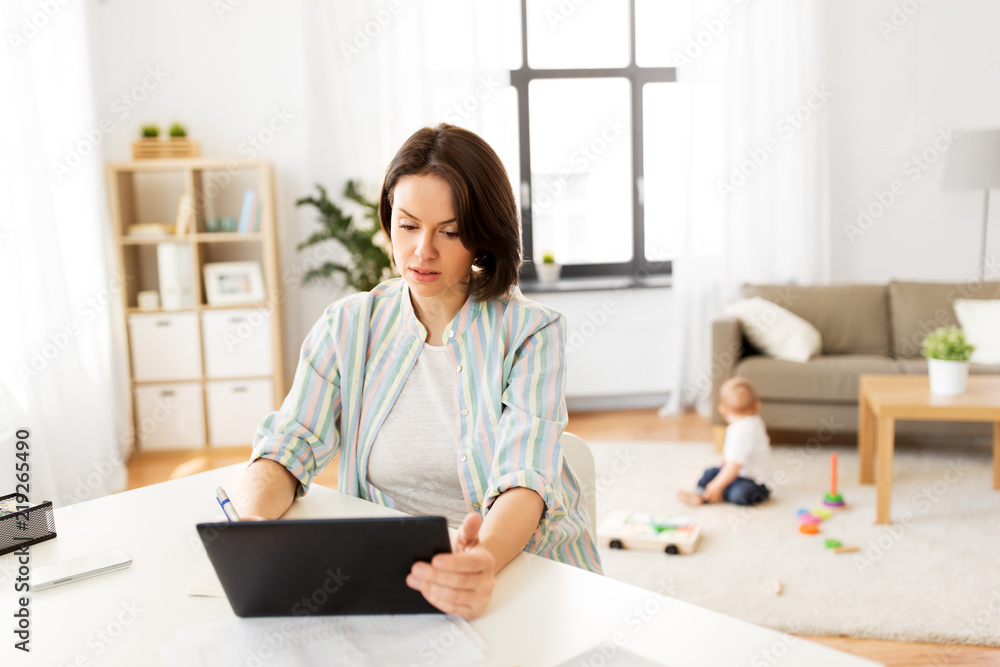 multi-tasking, freelance and motherhood concept - working mother with tablet pc computer and baby boy at home multi-tasking, freelance and motherhood concept - working mother with tablet pc computer and baby boy at home