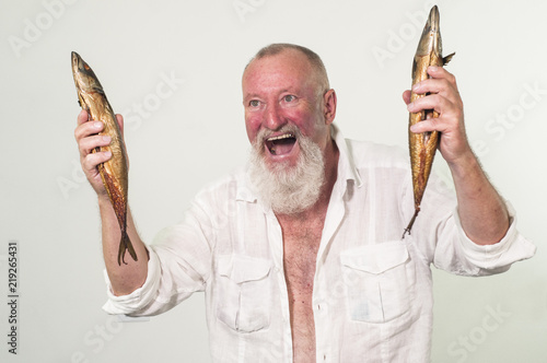 Satisfied and crazy man with 2 fishes in his hands, gray hair
