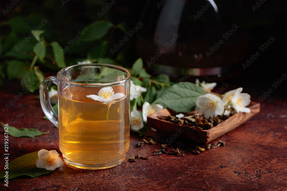 Green tea with jasmine in cup and teapot . Green tea with jasmine in cup and teapot .
