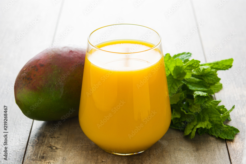 Fototapeta premium Mango Lassi dessert. Traditional Indian drink on wooden table. Copyspace