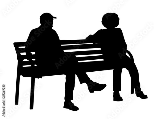 Two persons silhouettes sitting on a bench