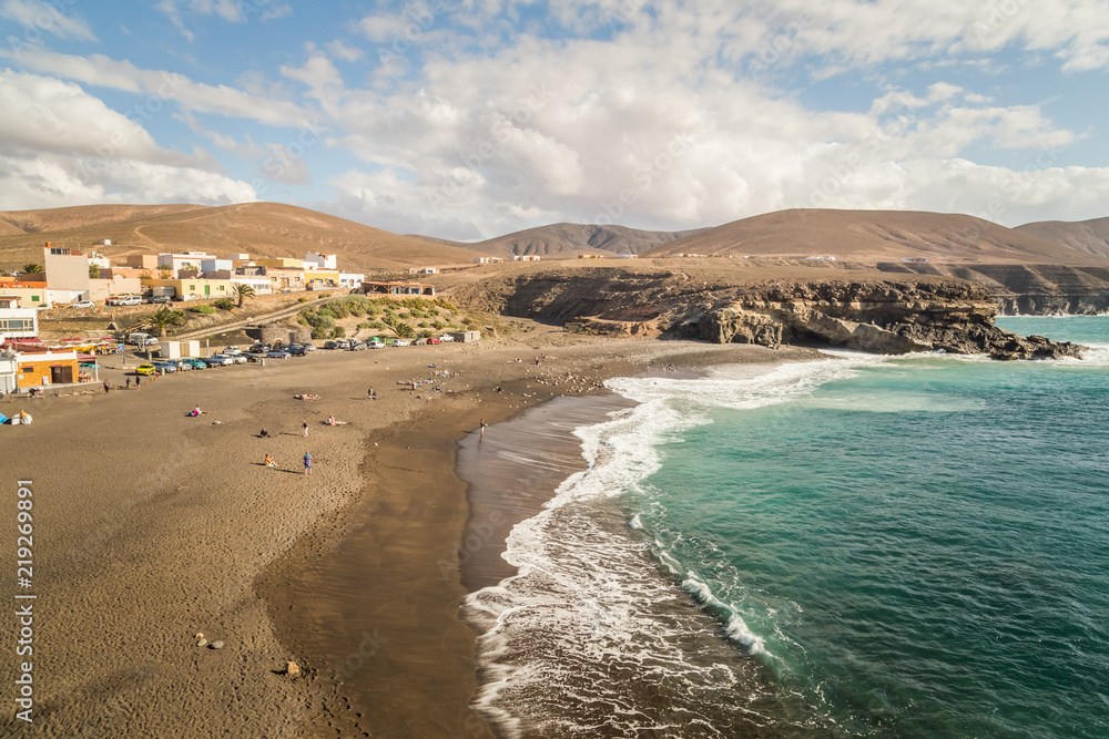 View of sandy beach and village of Ajuy, Fuerteventura, Canary Islands.
