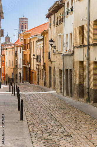 Street with colorful houses and cathedral tower in Tudela  Spain