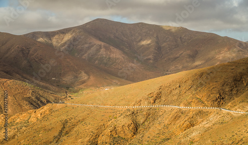Rocky hill landscape with winding road in Fuerteventura.