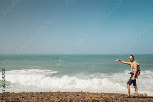 Father carrying baby on beach in Ajuy, Fuerteventura.