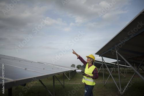 Engineer electric woman checking and maintenance of solar cells.