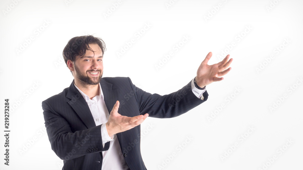 Happy smiling young man with a phone presenting and showing your text or product isolated on white background. Happy smiling young man with a phone presenting and showing your text or product isolated on white background.
