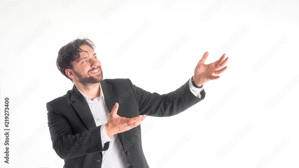 Happy smiling young man with a phone presenting and showing your text or product isolated on white background. Happy smiling young man with a phone presenting and showing your text or product isolated on white background.
