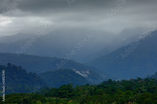 Foothills of Monteverde Cloud Forest Reserve, Costa Rica. Tropical mountains with grey storm clouds. Rainy day in the forest.