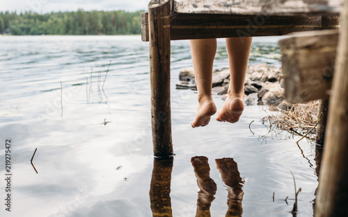 Woman sitting on a jetty photo