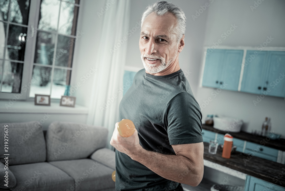 Do sport. Cheerful pensioner expressing positivity while looking straight at camera Do sport. Cheerful pensioner expressing positivity while looking straight at camera