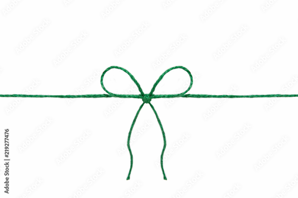 Green jute twine hemp rope, tie a knot / bow in the middle of the cord. Isolated on white background. Green jute twine hemp rope, tie a knot / bow in the middle of the cord. Isolated on white background.