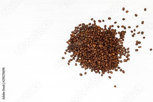 Coffee beans on white wooden background