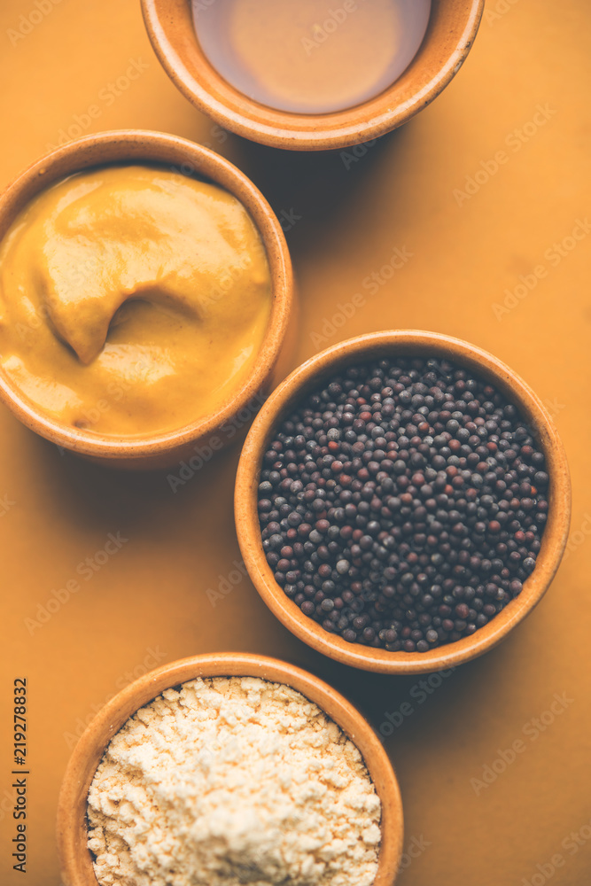 Rai or raw Mustard with sauce, powder and oil, over moody background. Selective focus
Rai or raw Mustard with sauce, powder and oil, over moody background. Selective focus