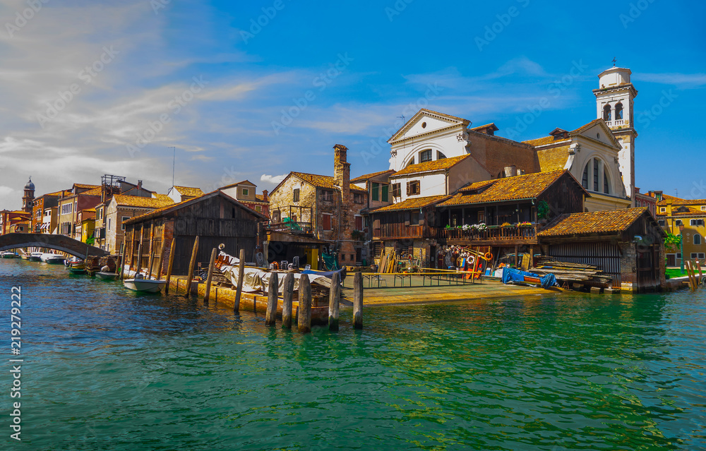 The historic district of Venice without tourists: old houses and churches in the traditional architecture of the Veneto region, turquoise water, canal view and boats, summer photo with beautiful sky The historic district of Venice without tourists: old houses and churches in the traditional architecture of the Veneto region, turquoise water, canal view and boats, summer photo with beautiful sky