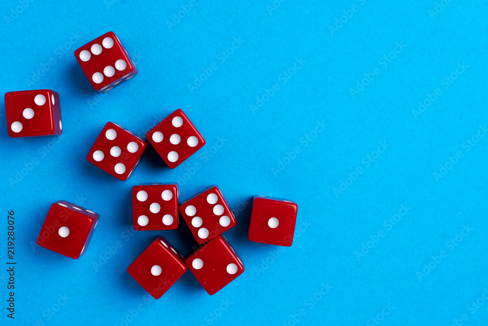 Red gaming dices on blue background. Flat lay, place for text. Game concept Red gaming dices on blue background. Flat lay, place for text. Game concept