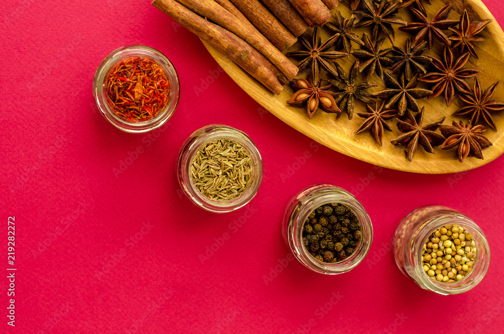 spices on a plate and jars on a violet background