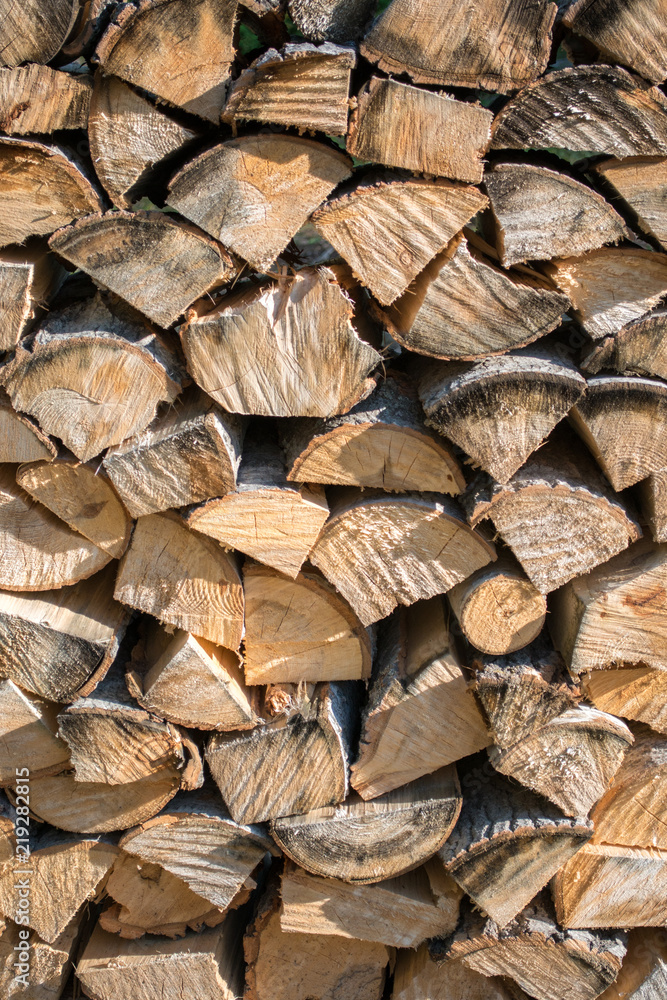 Cut split stacked firewood for winter background close-up