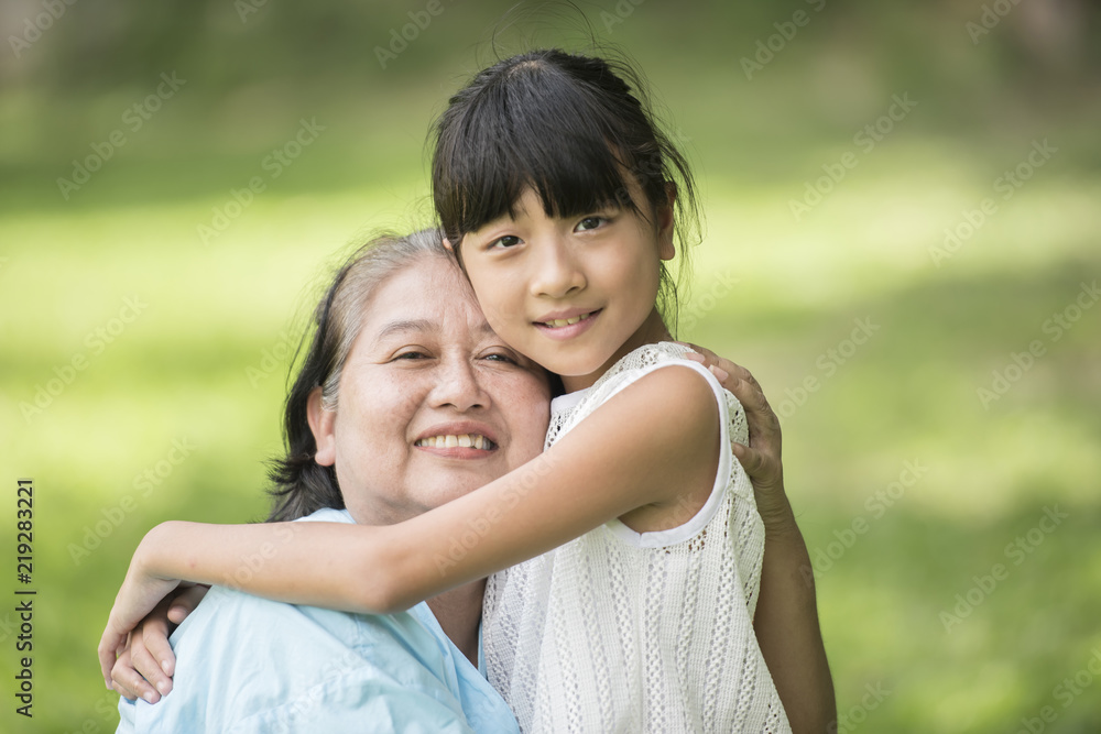 Elderly grandmother in wheelchair with granddaughter in the hospital garden Elderly grandmother in wheelchair with granddaughter in the hospital garden