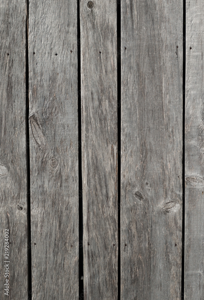 Fototapeta premium Weathered gray raw wood boards background wallpaper