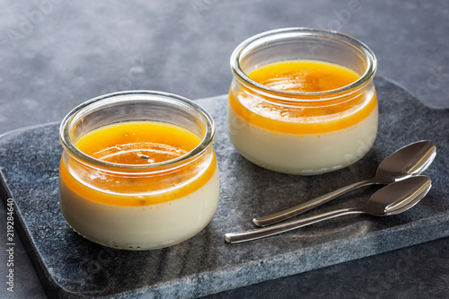 Tropical Passionfruit Panna Cotta, a Creamy Italian Pudding with a Passion Fruit Gelatin Layer, on Granite Cutting Board