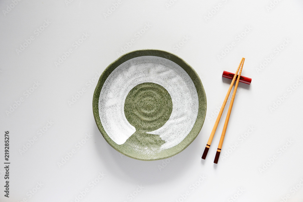 Ceramic plate green and wood Chopsticks oriental style,Copy space,Flat lay Ceramic plate green and wood Chopsticks oriental style,Copy space,Flat lay