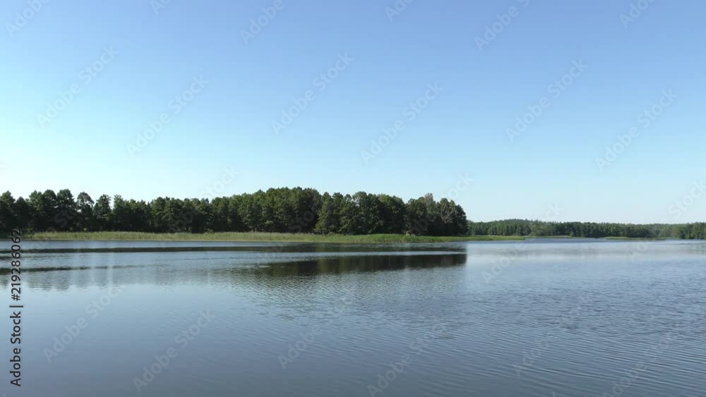 Polish lake. Beautiful lake, trees in the background. Panning,Closeup, Polish lake. Beautiful lake, trees in the background. Panning,Closeup,