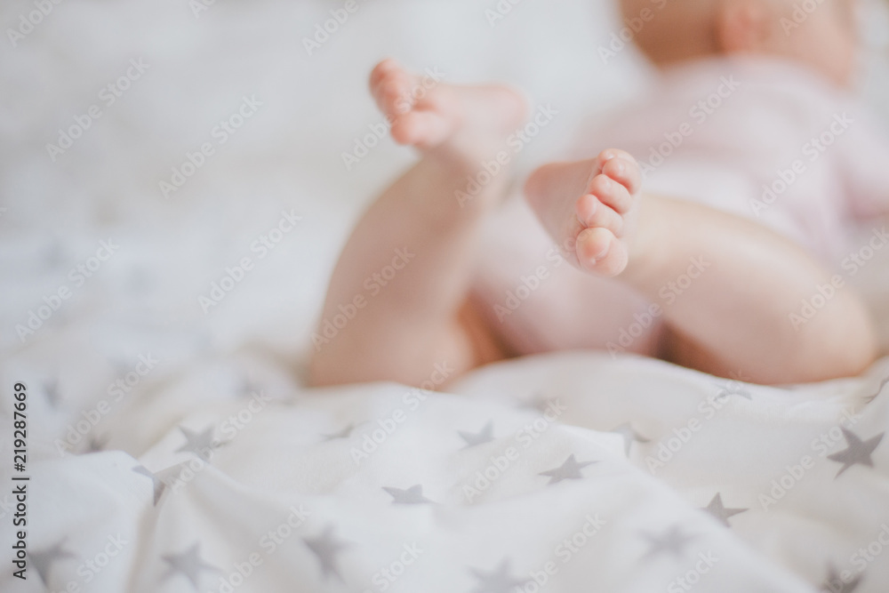 Little baby feet on a swaddle blanket Little baby feet on a swaddle blanket