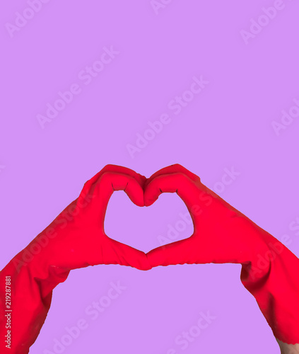 Hands in an economic glove of red color for household chemistry are isolated on colored backgrounds for a design