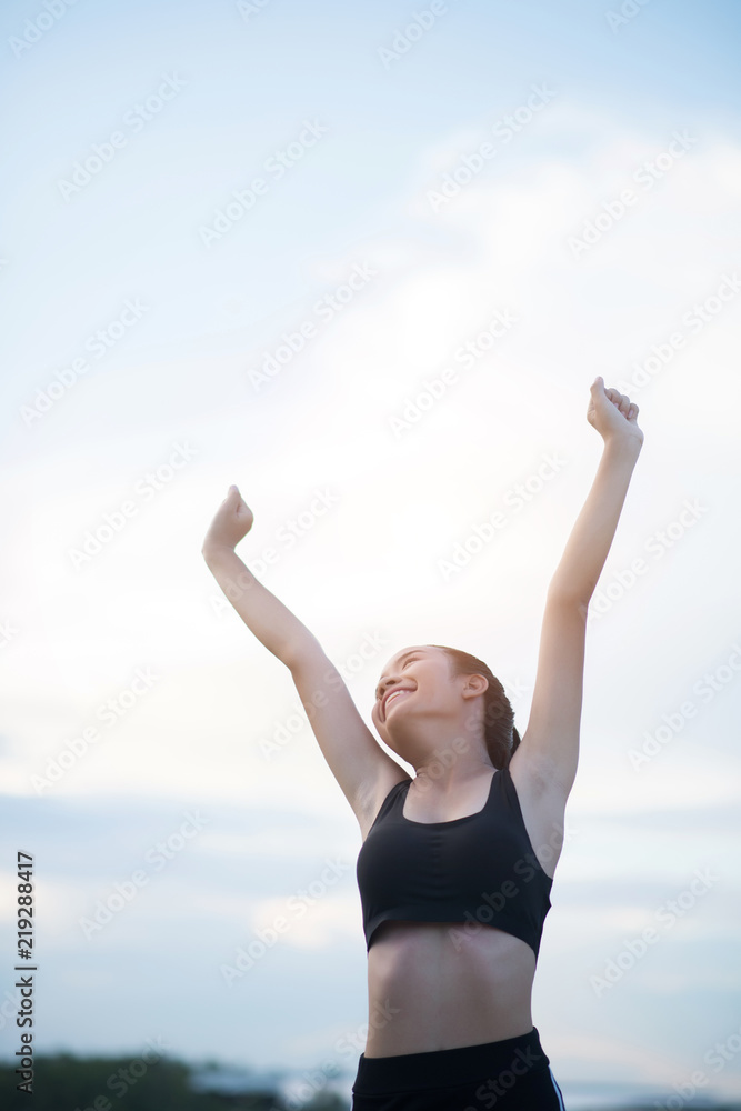 Happy smiling athletic woman with arms outstretched Happy smiling athletic woman with arms outstretched