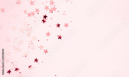 Festive pink background. Shining stars on light pink pastel background. Christmas. Wedding. Birthday. Happy woman s day. Mothers Day. Valentine s Day. Flat lay  top view  copy space. 