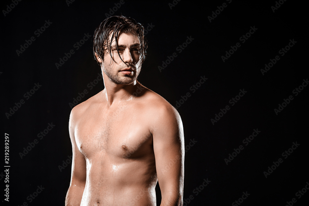 portrait of pensive shirtless man with wet hair looking away isolated on black portrait of pensive shirtless man with wet hair looking away isolated on black
