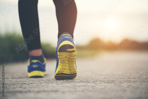 Slika na platnu Close up on running shoes Fitness women training and jogging