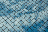 Background of the sky with clouds behind the fence of the fence