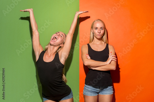 Why is that. Beautiful female half-length portrait isolated on trendy studio backgroud. Young emotional happy and unhappy women. Human different emotions, facial expression concept.