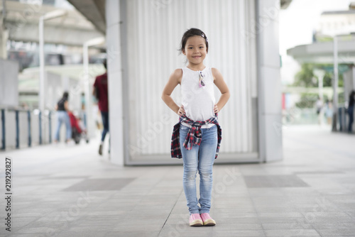 Smart little girl child standing in city