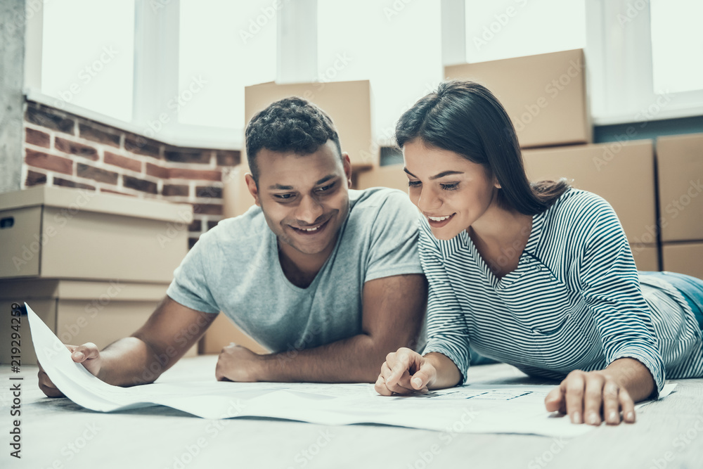 Young Smiling Couple Enjoy Moving in New House Young Smiling Couple Enjoy Moving in New House
